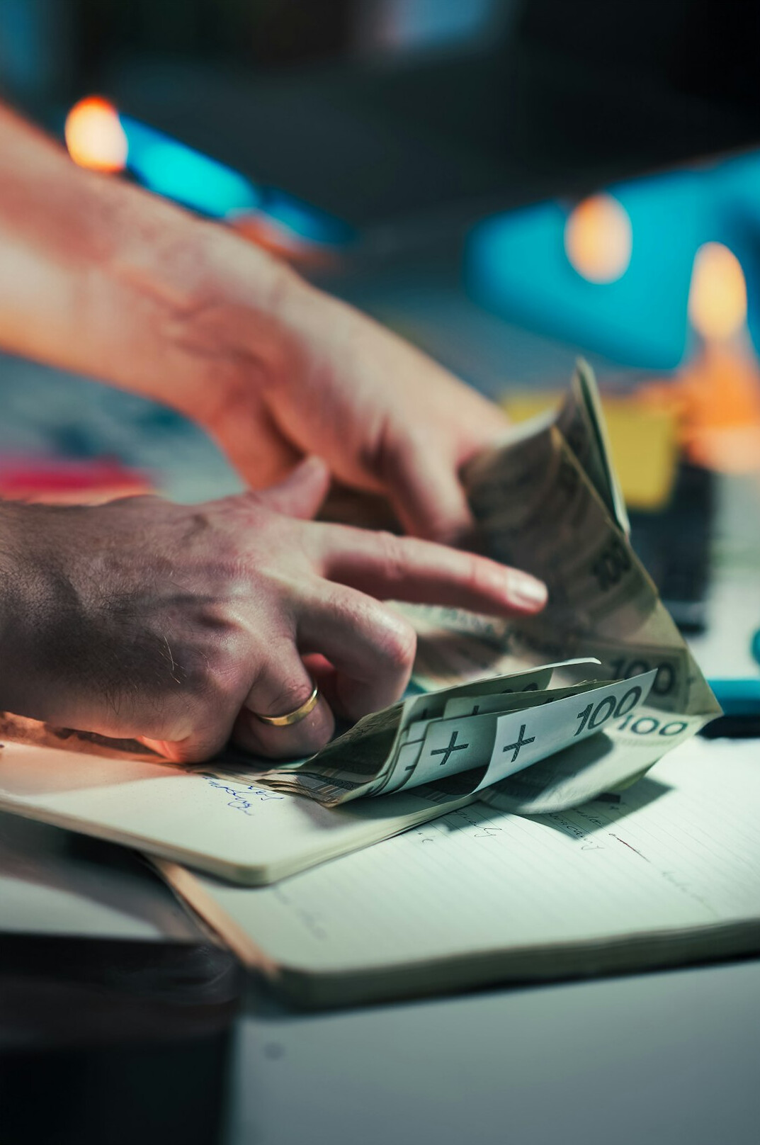person reviewing monthly budget with calculator